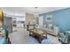 Open-concept living area with sleek wood flooring, calming blue walls, and seamless flow to the kitchen at 1210 Marrick Cir, Lakeland, FL 33815