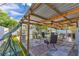 Covered patio with outdoor seating and a swing in a fenced backyard at 1210 Marrick Cir, Lakeland, FL 33815