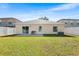 Large backyard with a white fence, green grass, and a patio, ideal for outdoor entertaining at 1216 Myopia Hunt Club Dr, Auburndale, FL 33823