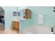 Bright bathroom featuring a large bathtub, a separate vanity area, and tile flooring at 1216 Myopia Hunt Club Dr, Auburndale, FL 33823