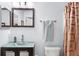 Bathroom with a glass vessel sink, bronze fixtures, decorative mirror, and framed shower curtain at 1216 Myopia Hunt Club Dr, Auburndale, FL 33823