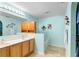 Bathroom includes a double sink vanity, bathtub, and a closet for extra storage at 1216 Myopia Hunt Club Dr, Auburndale, FL 33823