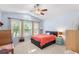 Bedroom with 3 large windows, a ceiling fan, and neutral carpet at 1216 Myopia Hunt Club Dr, Auburndale, FL 33823