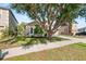 Charming single-Gathering home with a lush green lawn, mature trees, and a well-maintained landscape at 1216 Myopia Hunt Club Dr, Auburndale, FL 33823