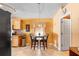 Eat-in kitchen boasts a round table with seating for four, warm wall color, and tile floors at 1216 Myopia Hunt Club Dr, Auburndale, FL 33823