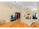Open living room and dining area offers ample space, featuring neutral carpet and light walls at 1216 Myopia Hunt Club Dr, Auburndale, FL 33823