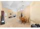 Open-concept living and dining area with neutral carpet, arched doorways, and ample natural light at 1216 Myopia Hunt Club Dr, Auburndale, FL 33823