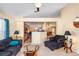 Well-lit living room with open design, featuring dark furnishings, natural light and easy access to the kitchen at 1216 Myopia Hunt Club Dr, Auburndale, FL 33823