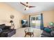 Comfortable living room with sliding glass doors to the backyard, featuring dark-colored furnishings at 1216 Myopia Hunt Club Dr, Auburndale, FL 33823