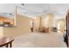 Bright living room with a dining area, featuring neutral carpet and easy access to the kitchen at 1216 Myopia Hunt Club Dr, Auburndale, FL 33823