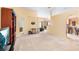 Expansive living area showcasing neutral tones, connecting seamlessly to the kitchen and other living spaces at 1216 Myopia Hunt Club Dr, Auburndale, FL 33823
