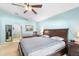Cozy main bedroom features soft carpeting, a ceiling fan, and classic wooden furniture at 1216 Myopia Hunt Club Dr, Auburndale, FL 33823