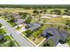 An aerial view showcases the homes surrounded by lush green lawns, trees, and a golf course nearby at 1295 Osprey Landing Dr, Lakeland, FL 33813