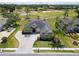 Aerial view of house showing front yard, driveway, and mature landscaping at 1295 Osprey Landing Dr, Lakeland, FL 33813
