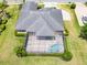 Aerial view of property, showing backyard pool, screen and manicured lawn at 1295 Osprey Landing Dr, Lakeland, FL 33813