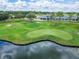 An aerial view shows the golf course and clubhouse next to the pond at 1295 Osprey Landing Dr, Lakeland, FL 33813