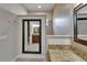 Bathroom featuring a vanity with granite counters, walk-in shower, and decorative mirror at 1295 Osprey Landing Dr, Lakeland, FL 33813