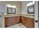 Bathroom featuring double sinks with granite counters and wood cabinets at 1295 Osprey Landing Dr, Lakeland, FL 33813