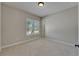 Spacious bedroom featuring carpet, neutral paint, and a window overlooking the front yard at 1295 Osprey Landing Dr, Lakeland, FL 33813
