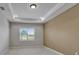 Bedroom showcasing neutral carpet, tray ceilings, recessed lights and large window at 1295 Osprey Landing Dr, Lakeland, FL 33813