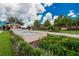 The community entrance features a brick wall, a fountain, and lush landscaping at 1295 Osprey Landing Dr, Lakeland, FL 33813