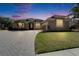 Dusk view of the home's exterior showcasing its inviting curb appeal and landscaping details at 1295 Osprey Landing Dr, Lakeland, FL 33813