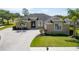 Stunning single-story home featuring a paved driveway, lush landscaping, and a welcoming entrance at 1295 Osprey Landing Dr, Lakeland, FL 33813