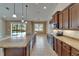 Open concept kitchen with granite island, stainless appliances, and a clear view to the pool area at 1295 Osprey Landing Dr, Lakeland, FL 33813