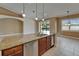 Kitchen island with stainless steel dishwasher and sink overlooking pool and outdoor living area at 1295 Osprey Landing Dr, Lakeland, FL 33813