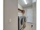 Laundry room featuring stainless steel washer and dryer and cabinets, access to the yard at 1295 Osprey Landing Dr, Lakeland, FL 33813
