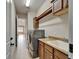 Laundry room with stainless steel washer and dryer, cabinets, and sink with granite counter at 1295 Osprey Landing Dr, Lakeland, FL 33813