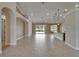 Spacious, open-concept living room with tile floors, recessed lighting, and sliding glass doors to the lanai at 1295 Osprey Landing Dr, Lakeland, FL 33813