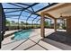 Large, screened-in lanai featuring a pool, ceiling fan, and view to golf course at 1295 Osprey Landing Dr, Lakeland, FL 33813
