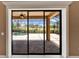 Covered lanai featuring a view of a pool, golf course, and outdoor entertaining space at 1295 Osprey Landing Dr, Lakeland, FL 33813