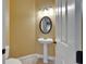 Powder room with a pedestal sink, decorative mirror, and neutral wall color at 1295 Osprey Landing Dr, Lakeland, FL 33813