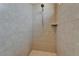 Shower with tile surround, a shower head, and a built-in shelf at 1295 Osprey Landing Dr, Lakeland, FL 33813