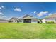 Green backyard view of home exterior with covered patio and well-maintained lawn at 1297 Pintail Pl, Lakeland, FL 33813