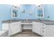 Bathroom boasts double vanities with granite countertops and wood-look floors at 1297 Pintail Pl, Lakeland, FL 33813