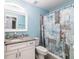 Bright bathroom featuring a vanity with granite countertop and stylish shower curtain at 1297 Pintail Pl, Lakeland, FL 33813