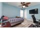 Bedroom with wood-look floors, ceiling fan, and a relaxing atmosphere at 1297 Pintail Pl, Lakeland, FL 33813