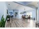 Open-concept dining area with wood floors, chandelier, and views of the connected living spaces at 1297 Pintail Pl, Lakeland, FL 33813