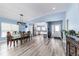 Open-concept dining area with wood floors, chandelier, and views of the connected kitchen space at 1297 Pintail Pl, Lakeland, FL 33813