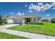 Charming single-story home featuring a two-car garage, stone accents, and beautifully landscaped front yard at 1297 Pintail Pl, Lakeland, FL 33813
