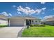 Charming single-story home featuring a two-car garage, stone accents, and beautifully landscaped front yard at 1297 Pintail Pl, Lakeland, FL 33813