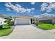 Charming single-story home featuring a two-car garage, stone accents, and beautifully landscaped front yard at 1297 Pintail Pl, Lakeland, FL 33813