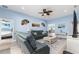 Comfortable living room with a ceiling fan, tile flooring, and views into other living spaces at 1297 Pintail Pl, Lakeland, FL 33813