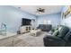 Cozy living room with a ceiling fan, tile flooring, and comfortable seating arrangements at 1297 Pintail Pl, Lakeland, FL 33813