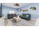 Comfortable living room with a ceiling fan, tile flooring, and cozy seating arrangements at 1297 Pintail Pl, Lakeland, FL 33813
