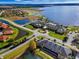 Breathtaking aerial view of a lakeside community with a large clubhouse and well-manicured grounds at 1394 Oakmont Dr, Winter Haven, FL 33884
