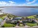 Aerial view of community featuring an amazing view of the lake and a gorgeous clubhouse with pool at 1394 Oakmont Dr, Winter Haven, FL 33884